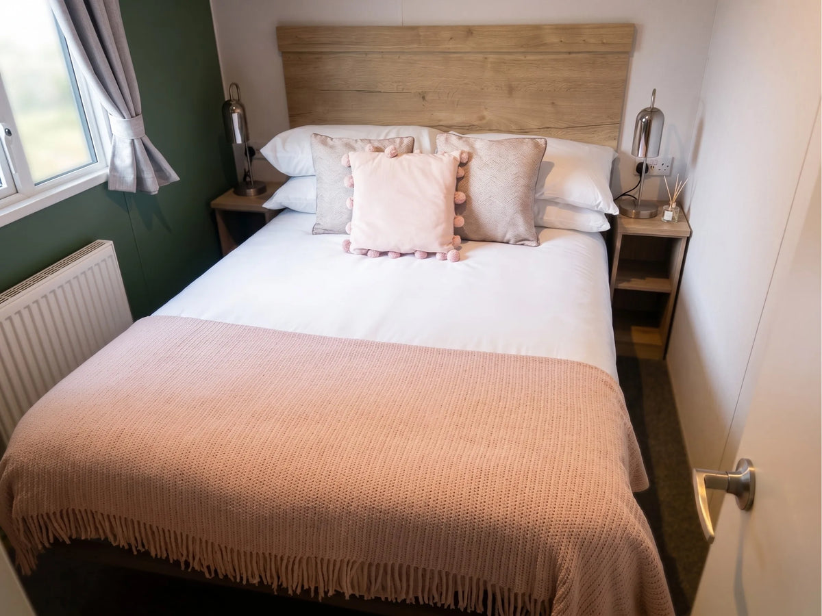 Comfortable master bedroom with double bed in the Midhurst holiday caravan