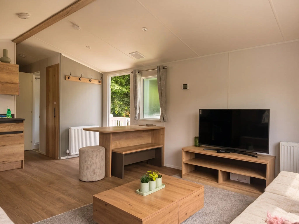 Open-plan lounge and dining area inside the Midhurst caravan at Crantock